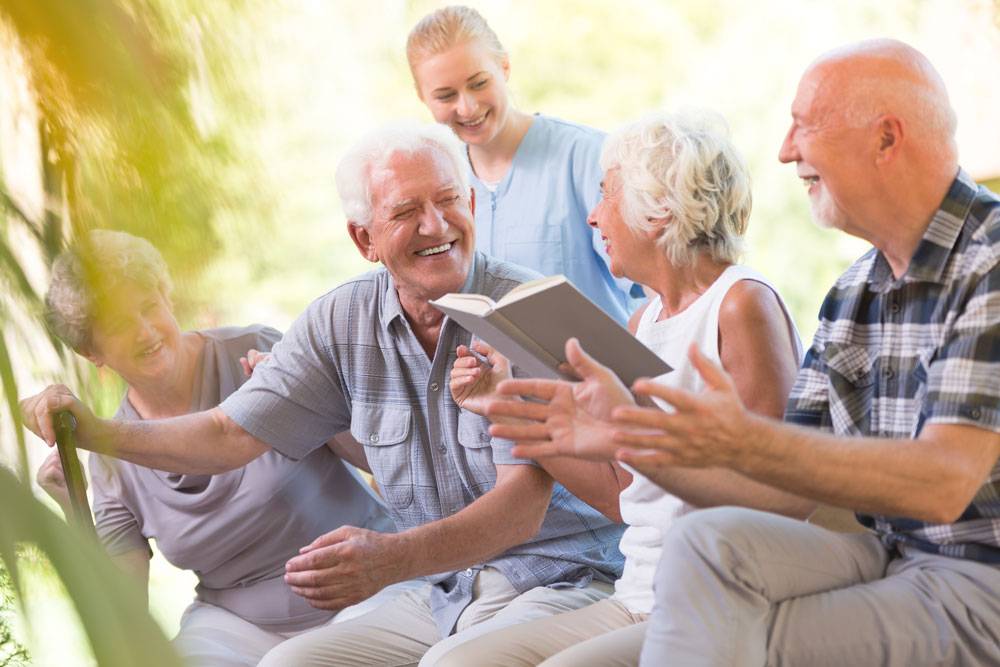 WLC residents reading a book outside